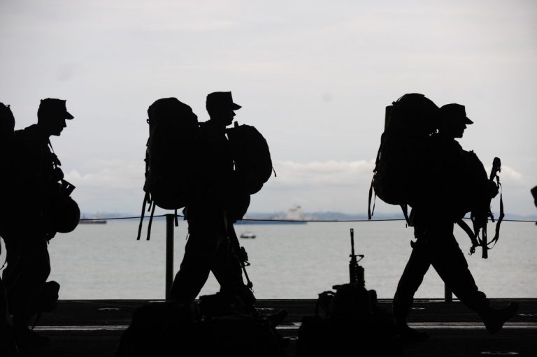 a group of people walking on a bridge