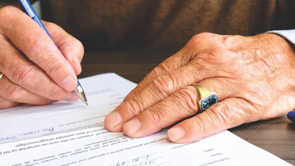 a person writing on a piece of paper