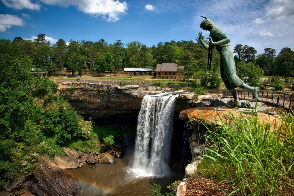 a statue of a person holding a torch and a torch