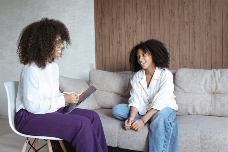 a person and a girl sitting on a couch