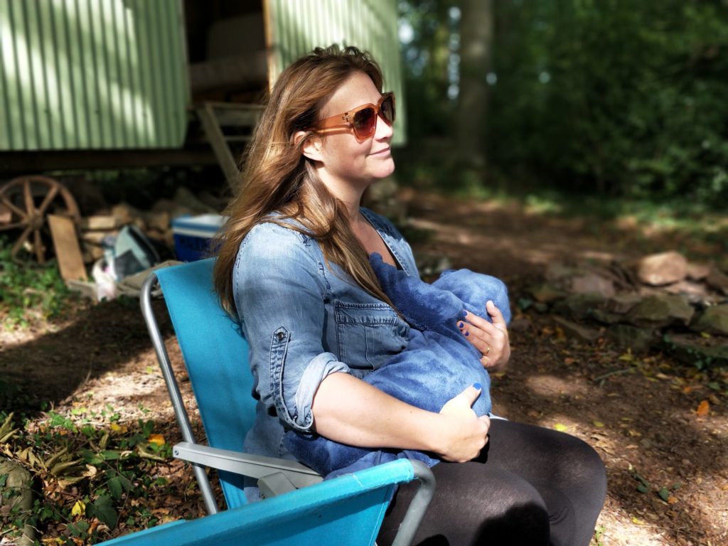 a woman sitting on a blue chair outside