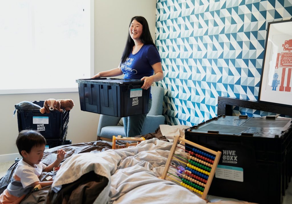 a person standing next to a boy in a room