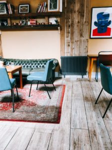 a room with chairs and a rug