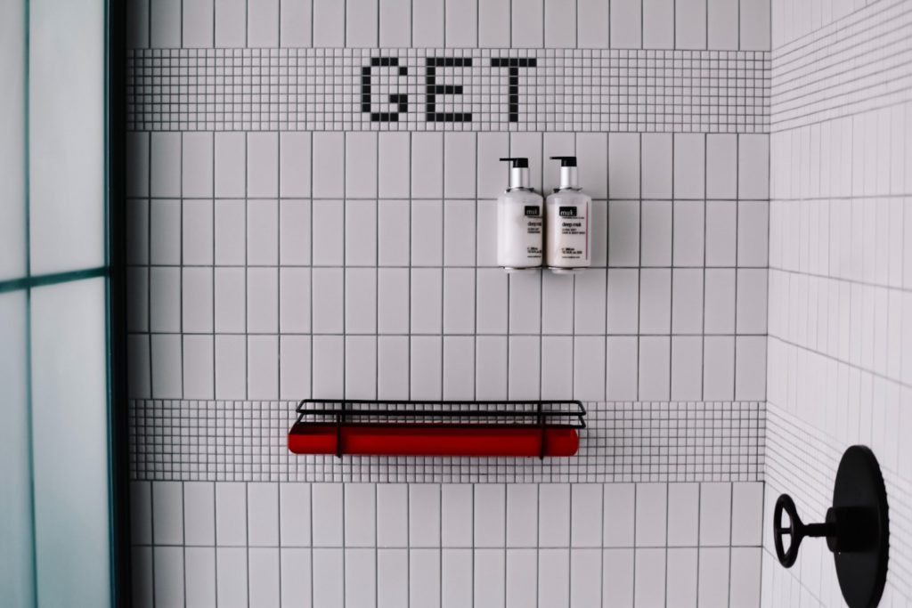 a red and black tool on a white tiled surface