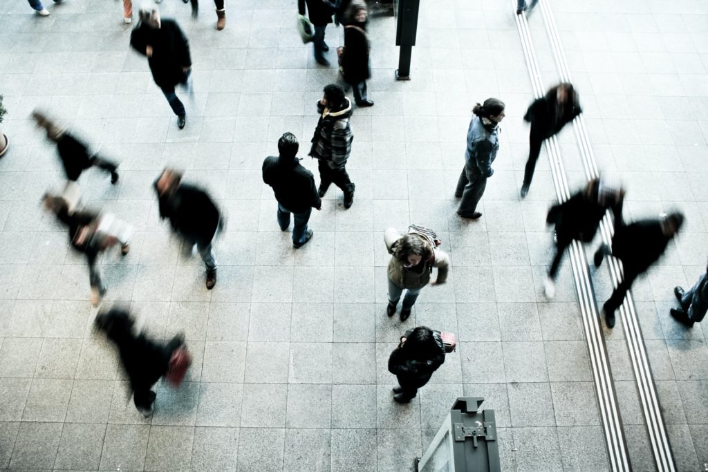 people walking on a sidewalk