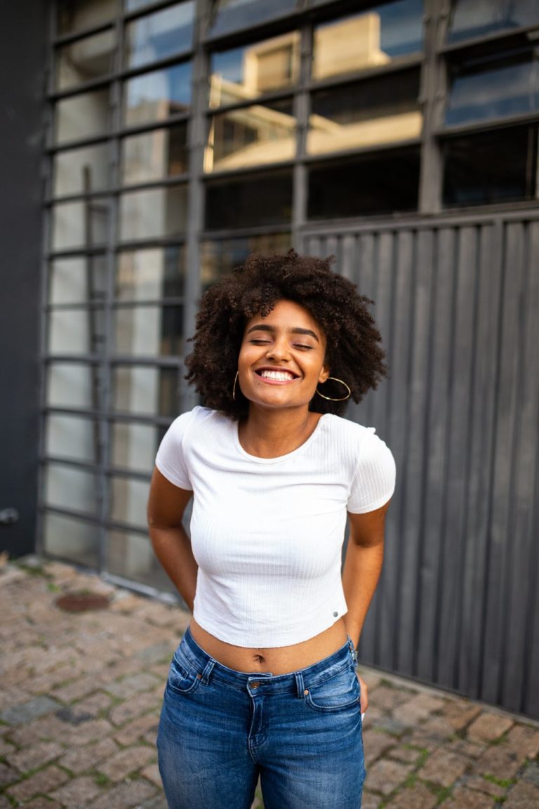 a person smiling in front of a building