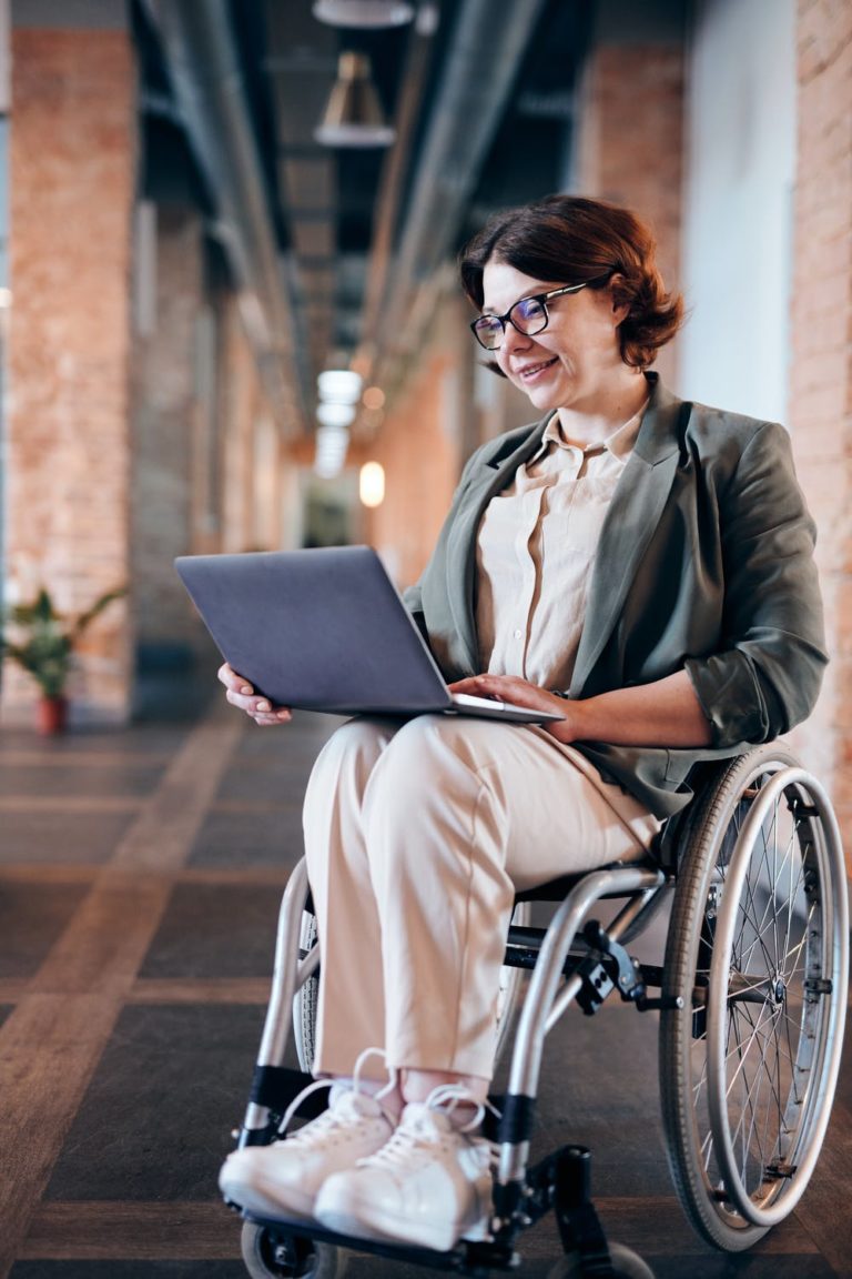 a person in a wheelchair using a laptop
