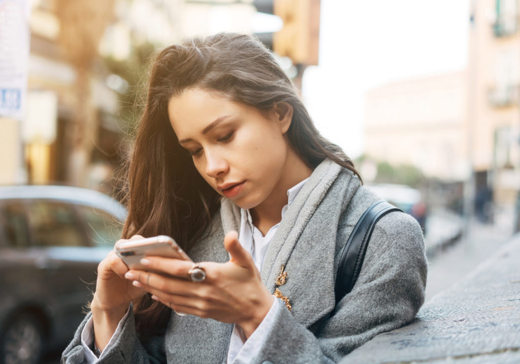 Woman using her mobile phone in the street.